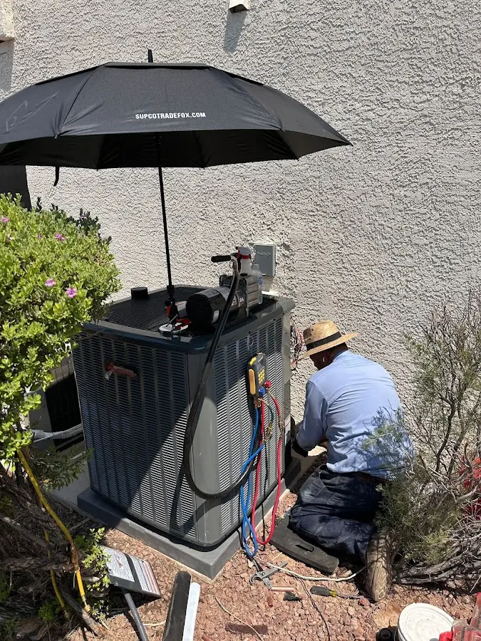 HVAC technician performing outdoor AC maintenance in Cape St. Claire
